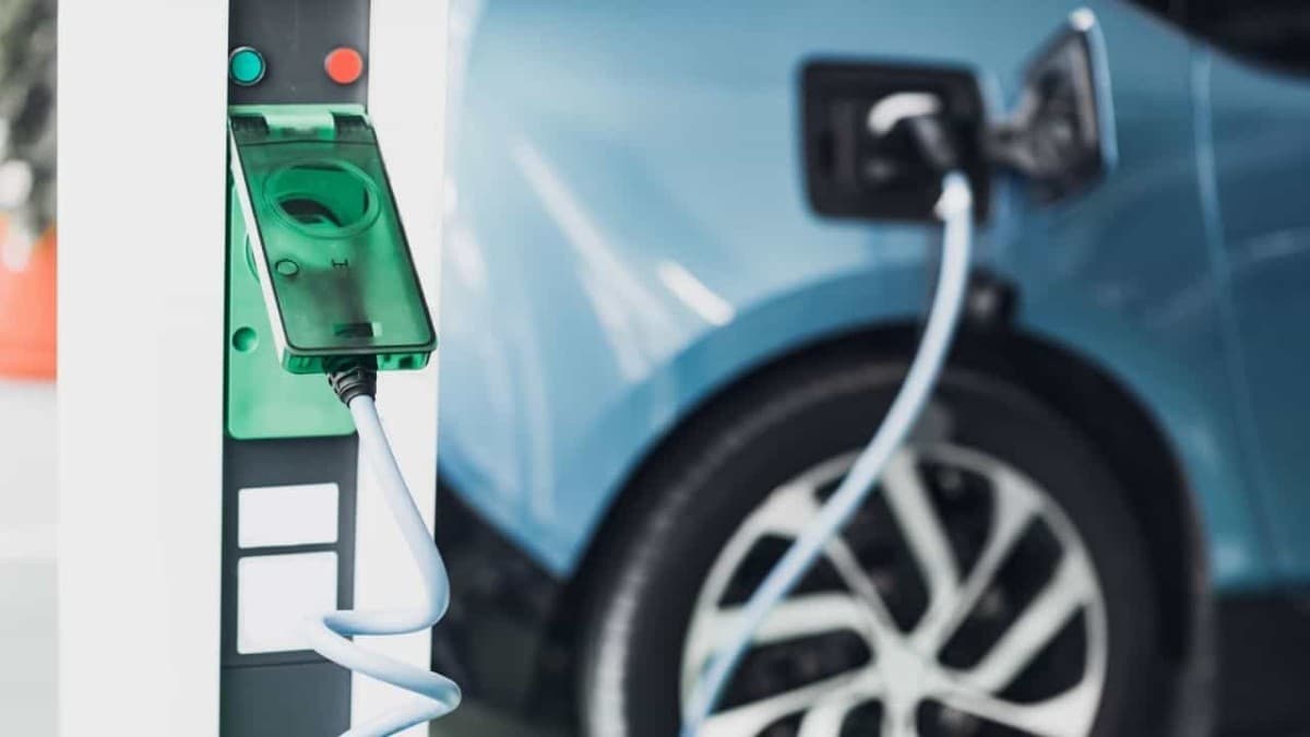 Electric vehicle plugged into a charging station