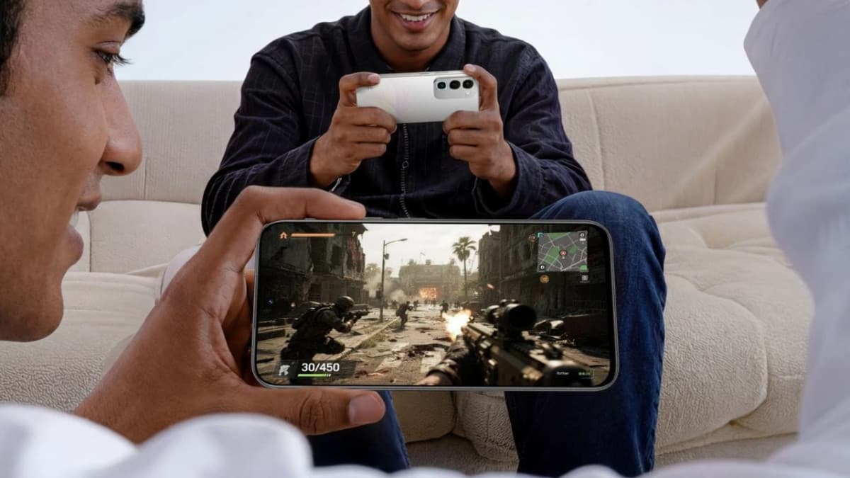 Two people playing games on realme 16x phones, one in the Glory White color
