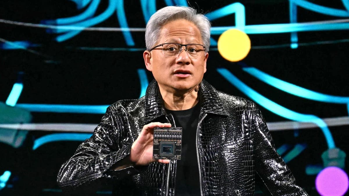 Nvidia CEO Jensen Huang holding up a chip at CES 2025